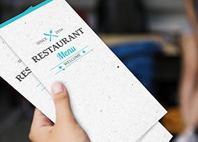 Single-use restaurant menus in hand